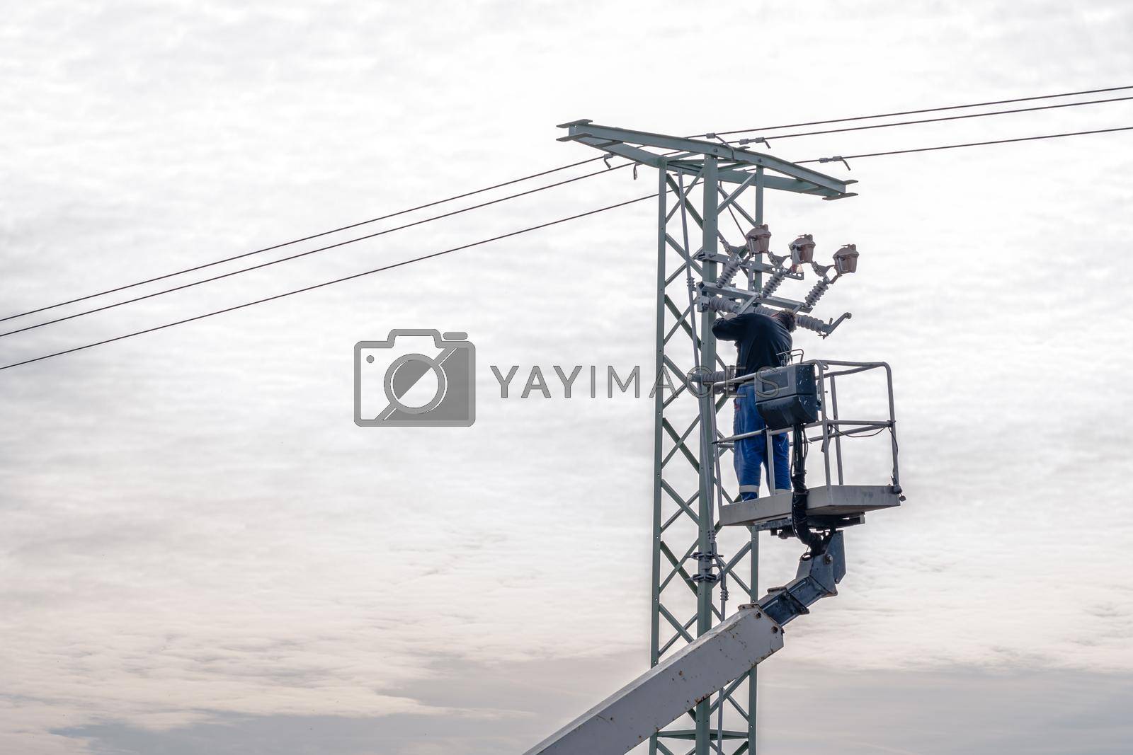 Royalty free image of repair of high voltage power line on the pole by Edophoto