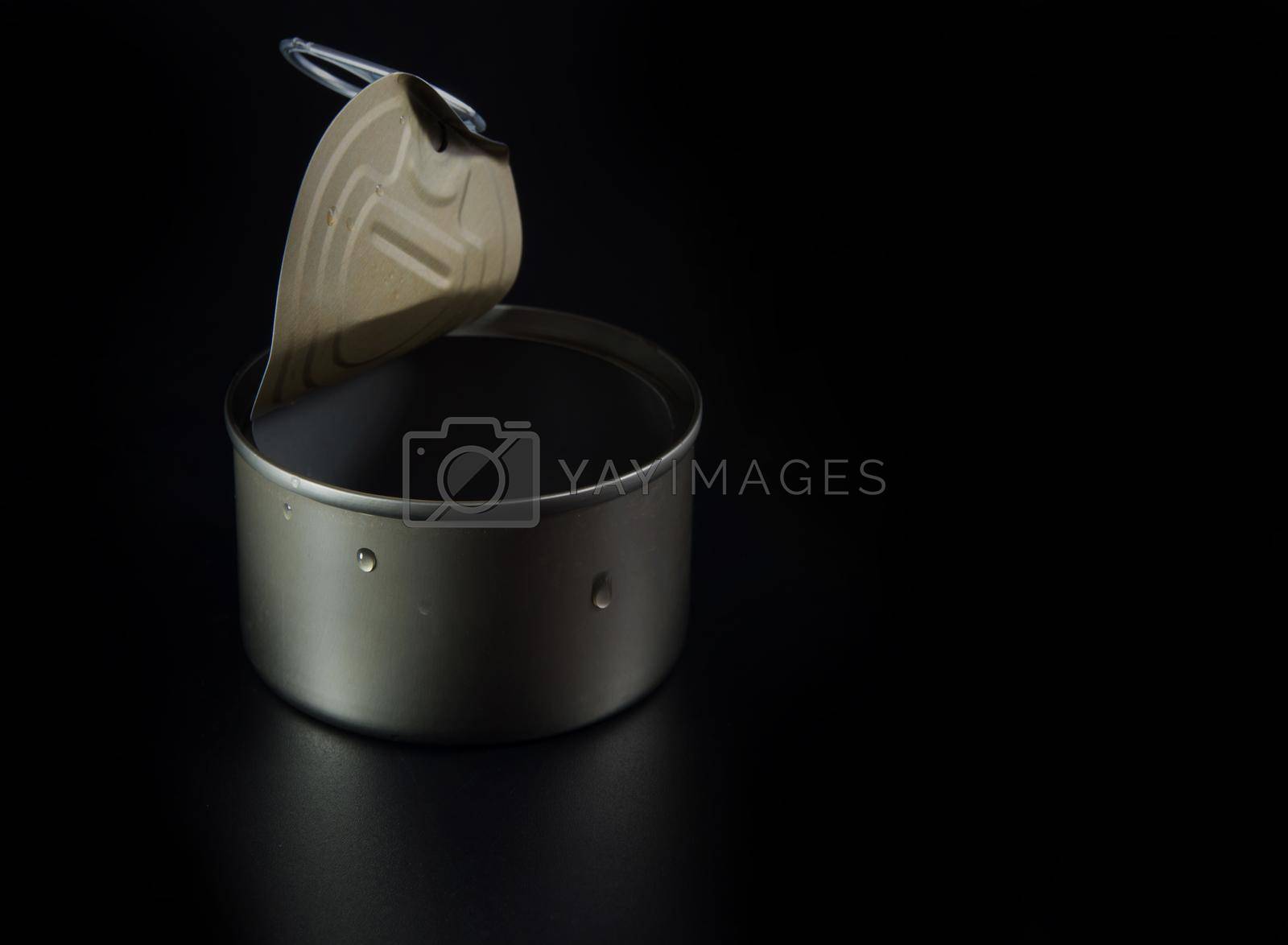Opened pull cap of empty food can on black background