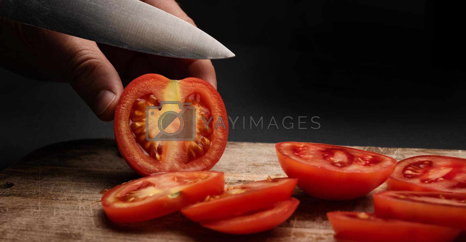 Royalty free image of Cherry tomatoes on wooden board by GekaSkr