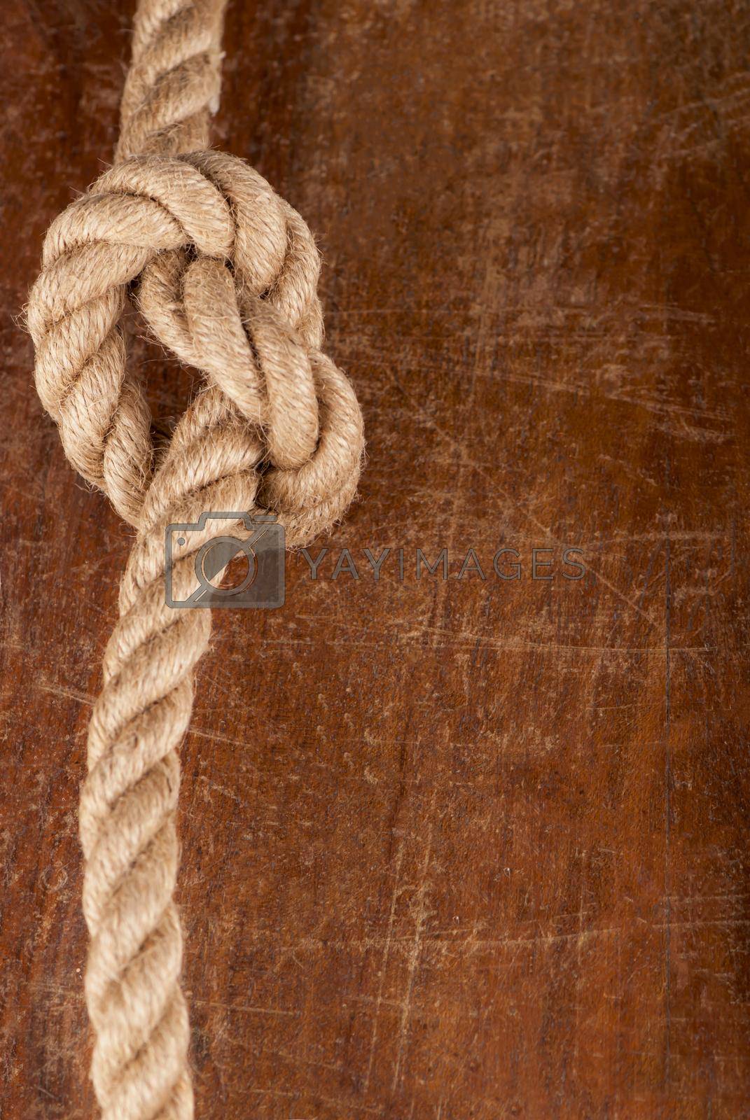 Rope with Reef Knot on Wood Texture Background