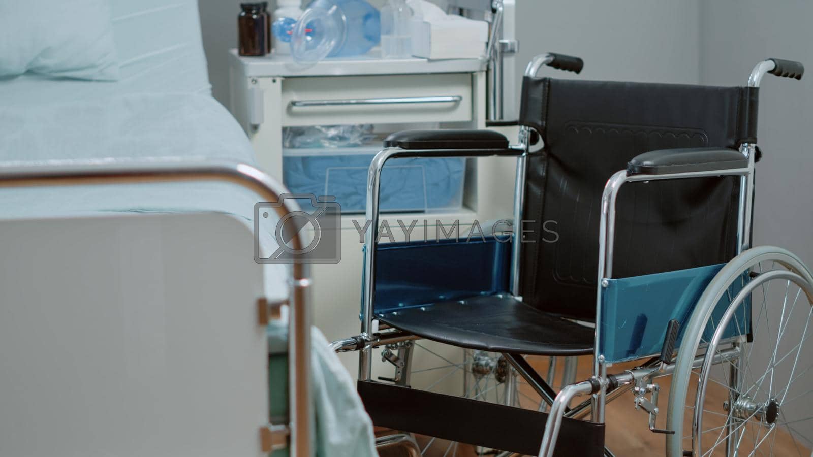 Close up of wheelchair in hospital ward for healthcare diagnosis and treatment. Nobody in bed at intensive care with oxygen tube and heart rate monitor for assistance and recovery.