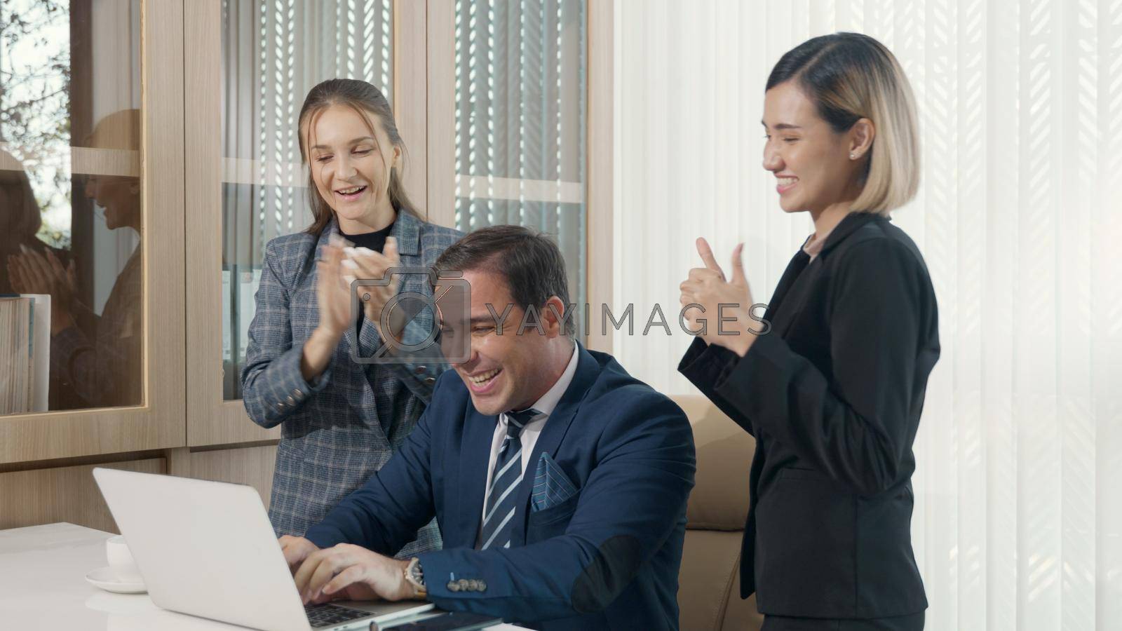 Royalty free image of Celebrating winners success project. Three happy business people team excited receiving good news together by Sorapop