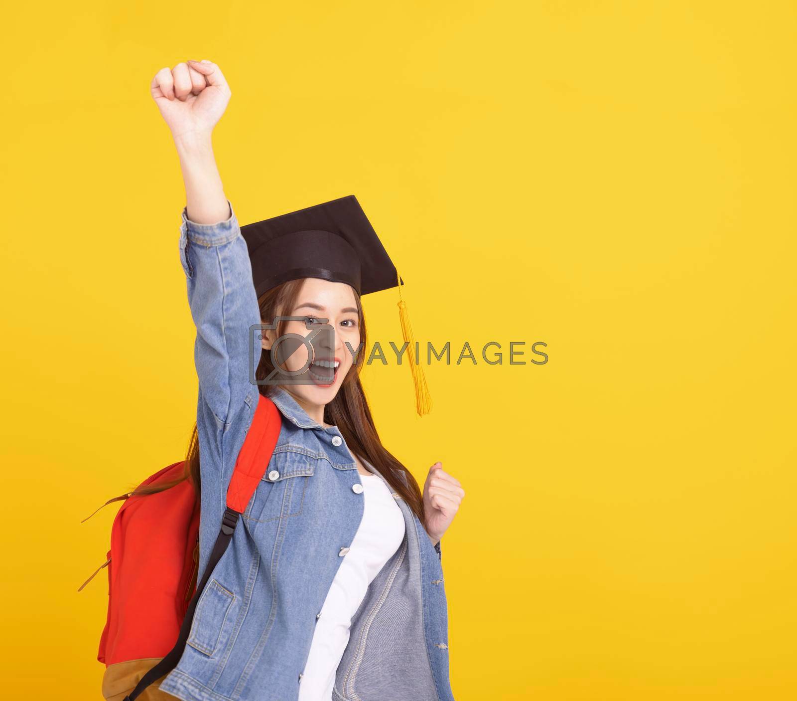 Royalty free image of Happy Asian girl college student in Graduation cap with success gesture by tomwang