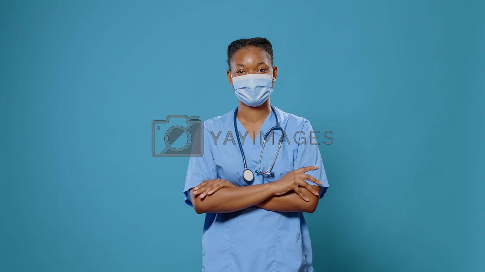 Royalty free image of Portrait of woman nurse with crossed arms wearing face mask by DCStudio