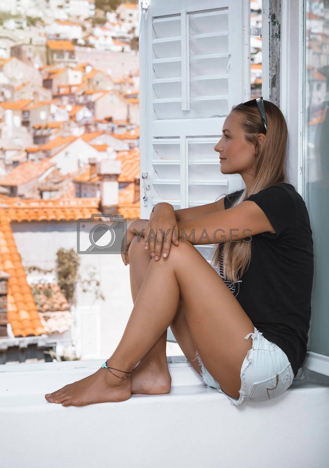 Nice Female Sitting on the Window in Little Cozy Hotel in Europe. Enjoying Beautiful Cityscape. Traditional Red Roofs in Dubrovnik. Croatia.