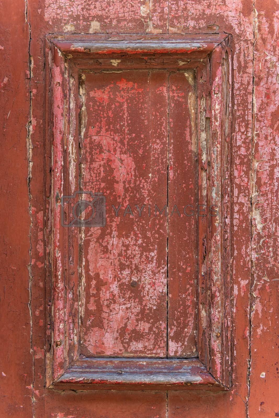 Frame part of a old wooden door painted on red.