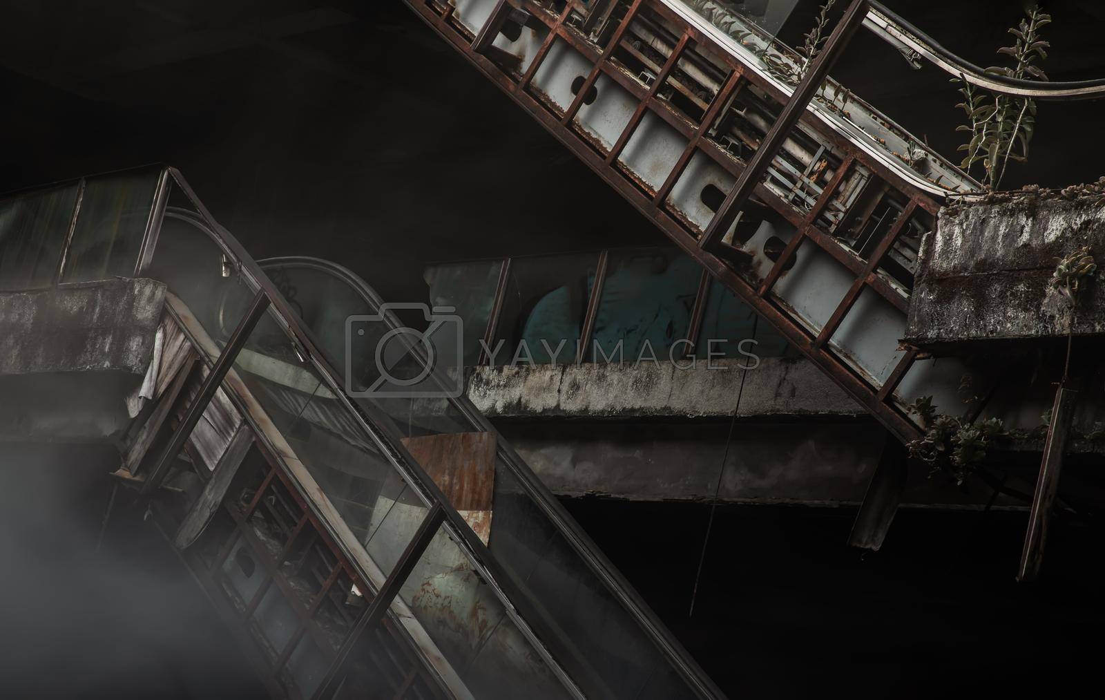Royalty free image of Damaged escalators in abandoned shopping mall building.  by tosirikul