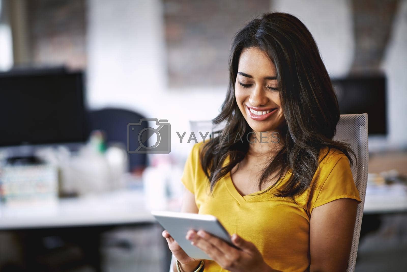 Royalty free image of Passion is the spark that illuminates your path to success. Shot of a young designer working on a digital tablet in an office. by YuriArcurs