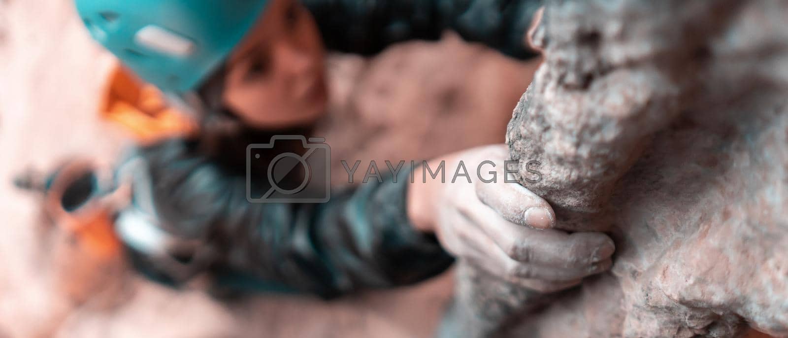 Royalty free image of Girl is climbing on the rocks, closeup view on hand. by africapink
