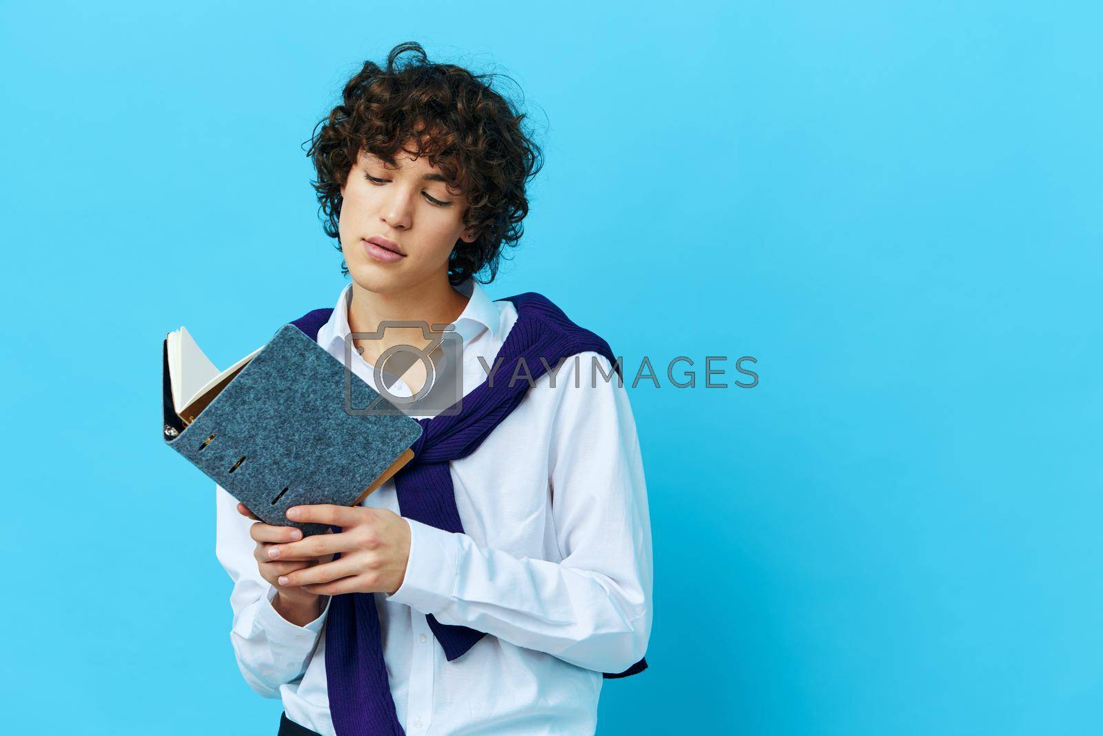 curly guy education with notepad hand gesture Lifestyle school. High quality photo