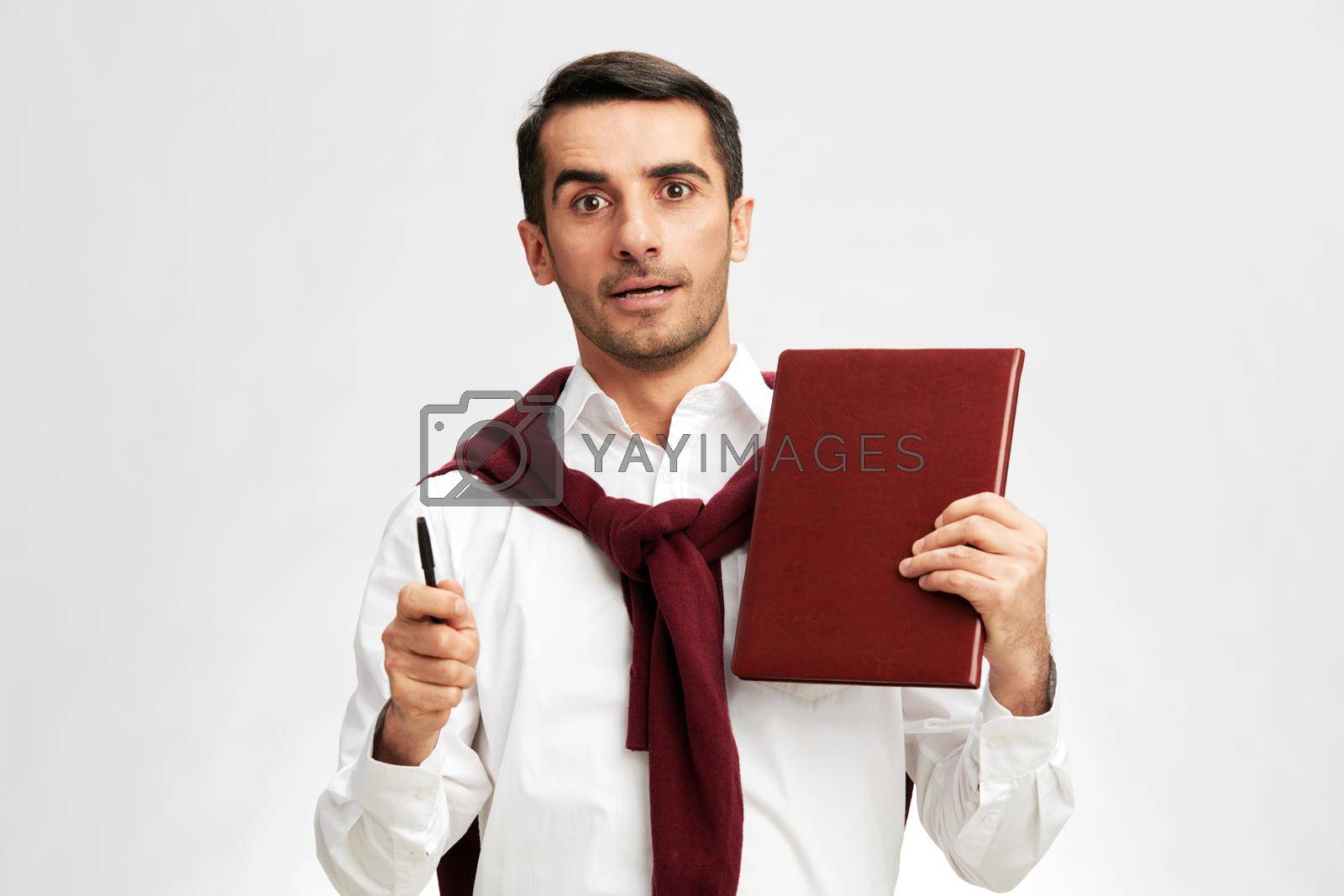 man notepad with pen emotions education light background. High quality photo