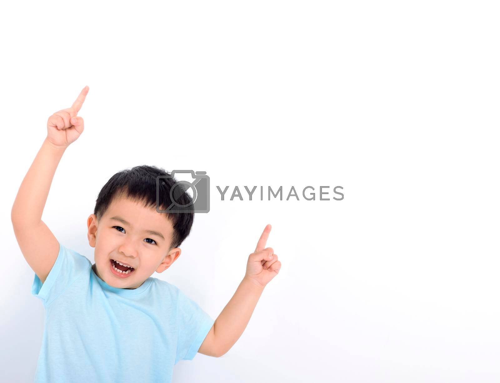 Royalty free image of Happy little boy pointing to copy space by tomwang