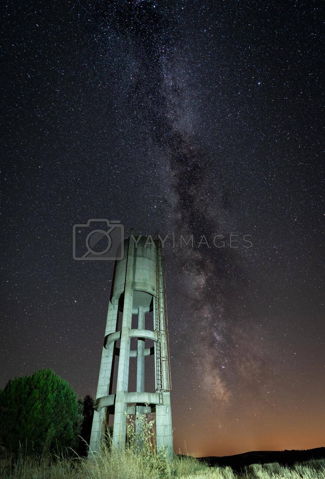 Royalty free image of Rusty concrete water Tank under the stars by FerradalFCG
