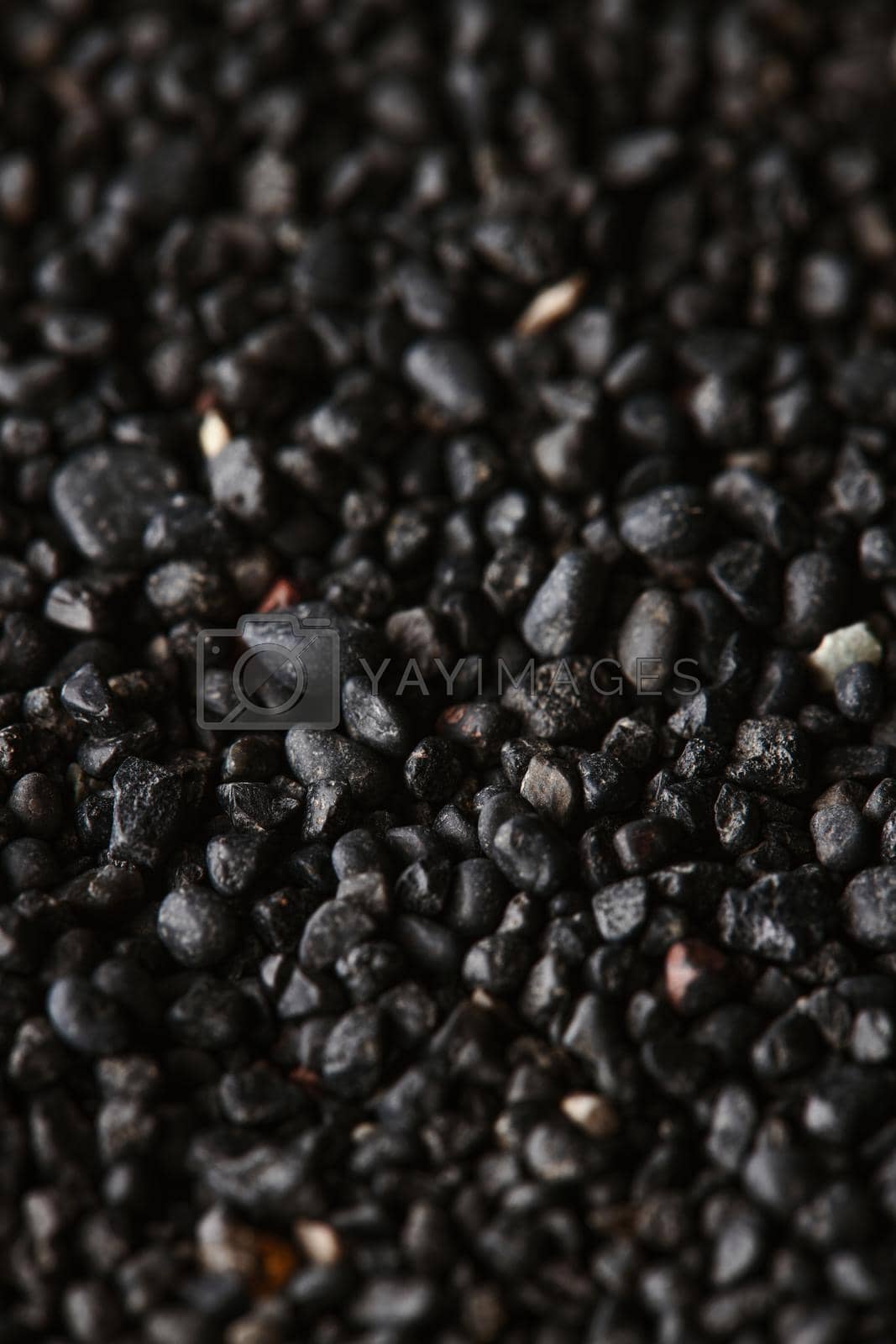 Royalty free image of Texture of black volcanic sand for background. Black Sand beach macro photography. Close-up view of volcanic sand surface. Icelandic Black Sand macro photography. Black pebble background by EvgeniyQW