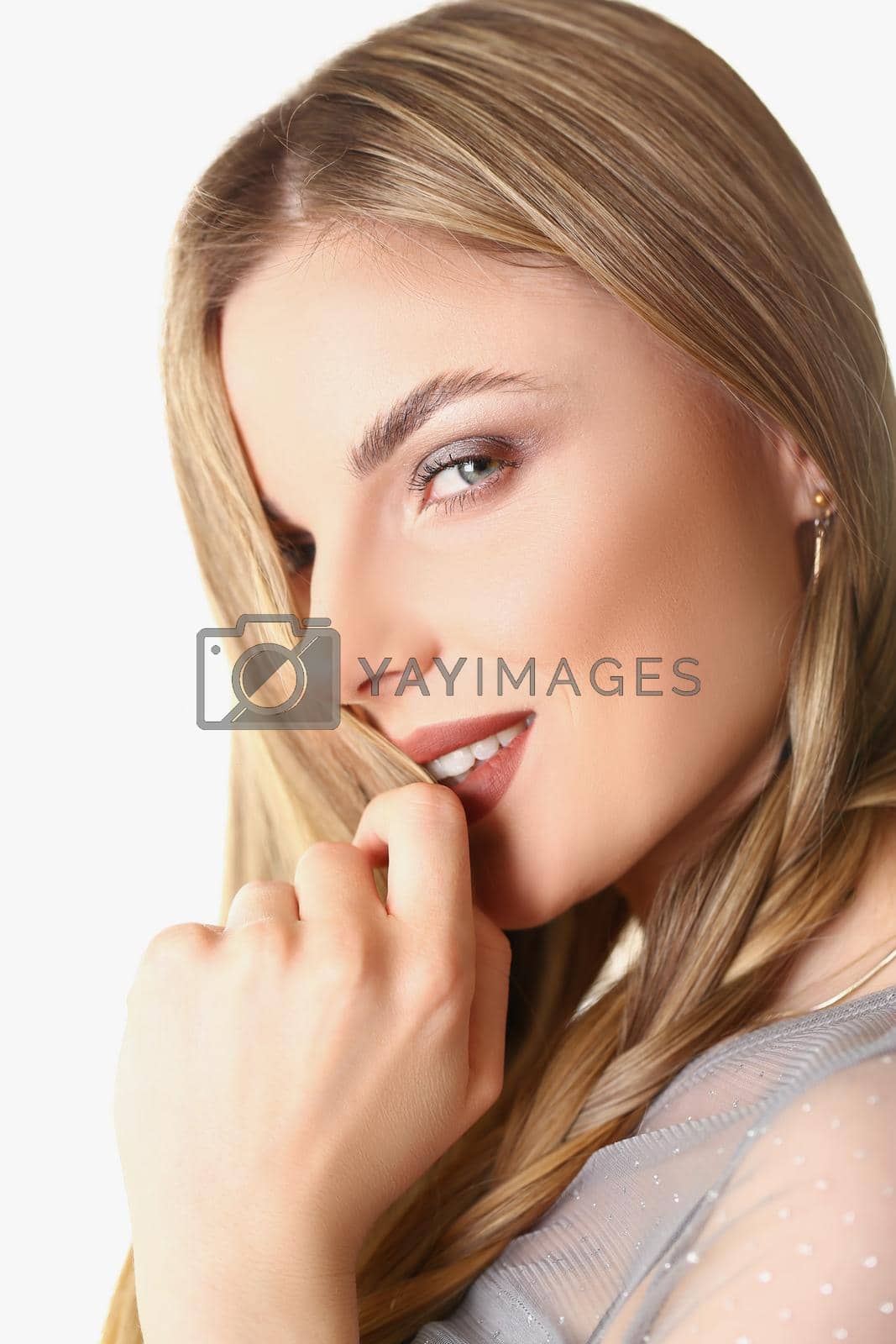 Royalty free image of Flirting young stylish blonde woman posing on white background in studio by kuprevich