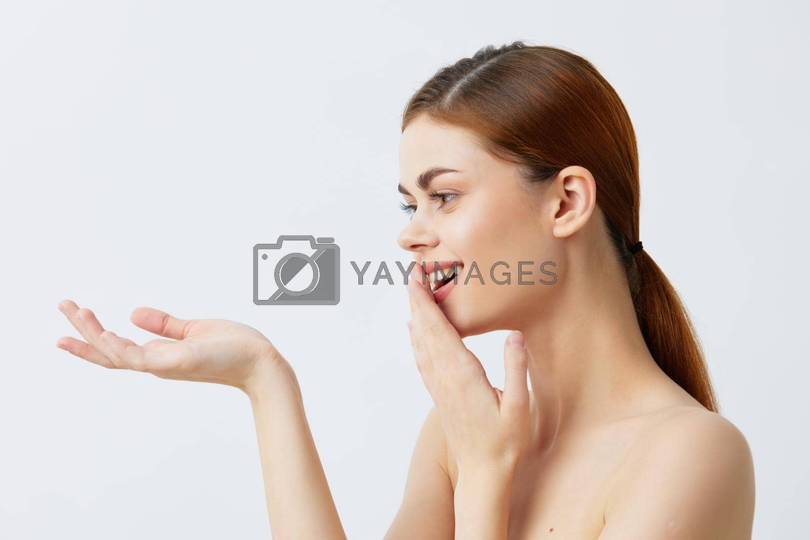 Royalty free image of young woman red hair bare shoulders cosmetics skincare isolated background by SHOTPRIME