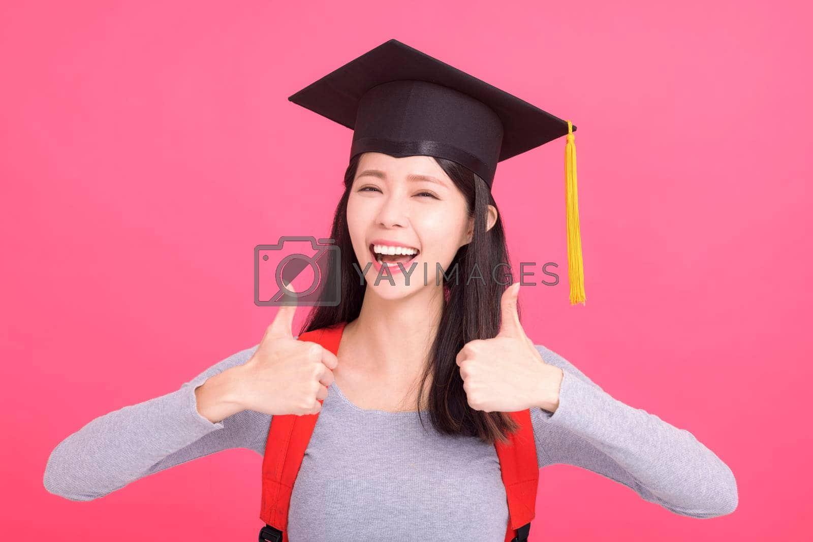 Royalty free image of Excited asian  girl college student in Graduation cap  with success gesture by tomwang
