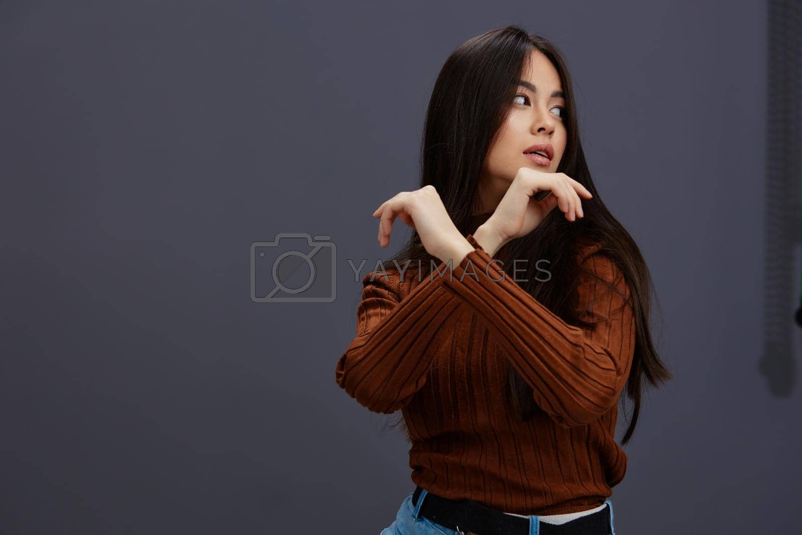Brunette hand gestures brown sweater fashion Lifestyle. High quality photo