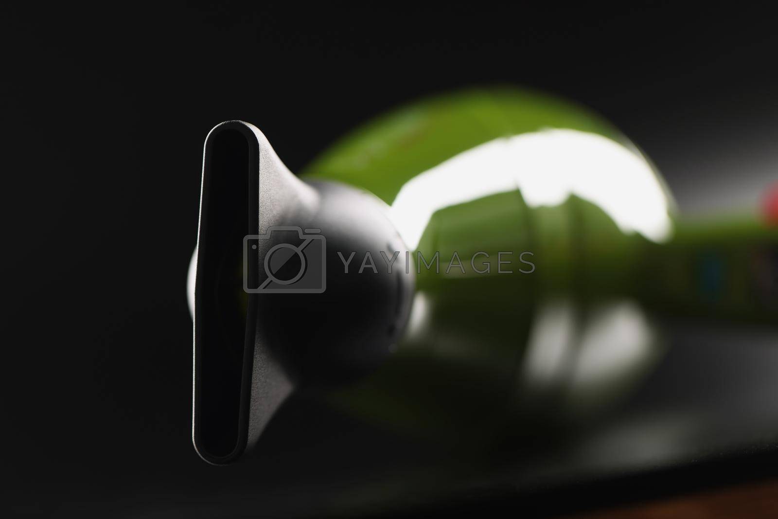 Royalty free image of Green professional hairdryer device with nozzle on black background, tool for hair master by kuprevich
