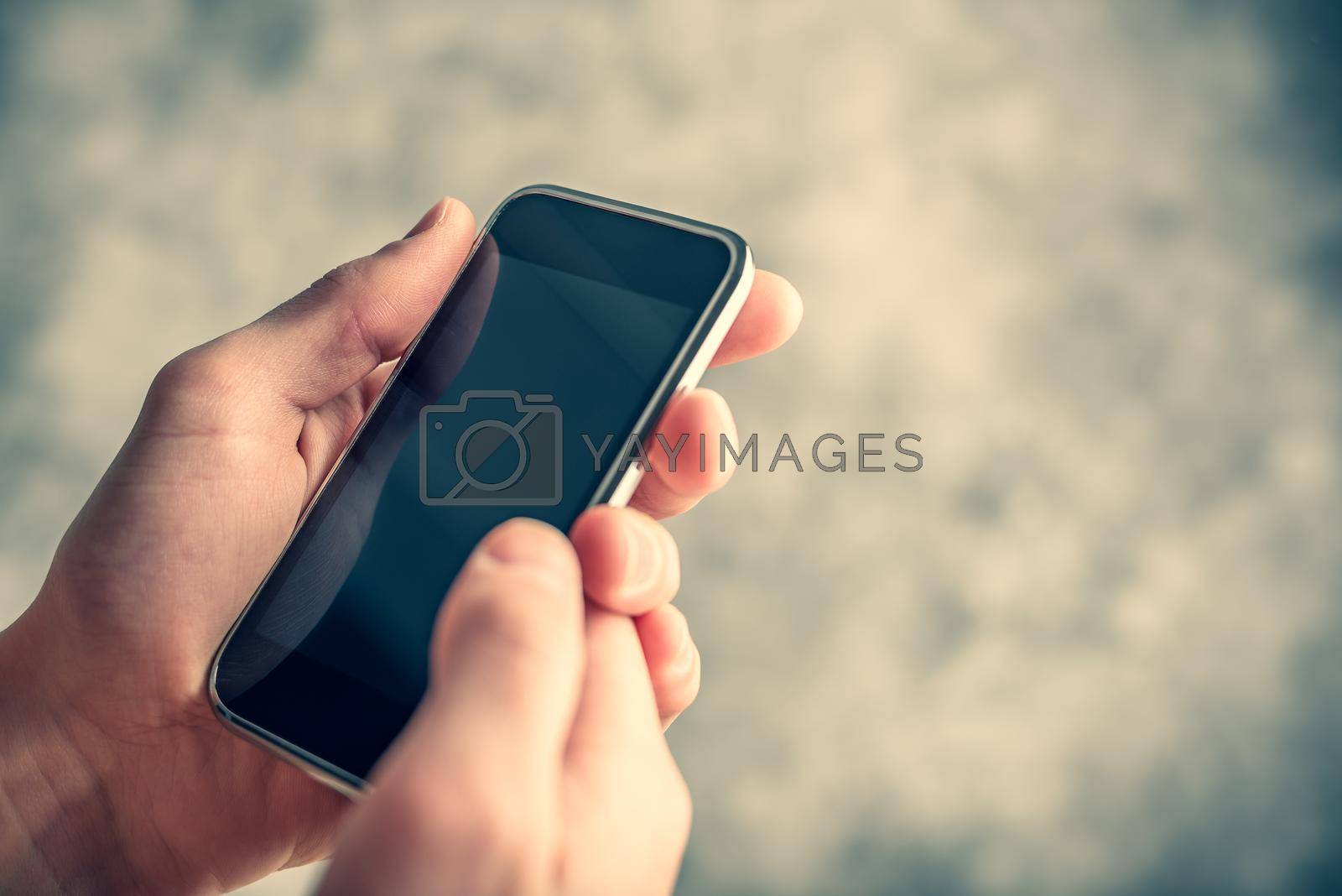 Royalty free image of Smart cell phone in hand by Seva_blsv