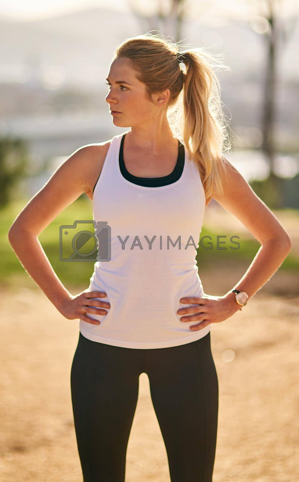 Royalty free image of Get up and get out there. Shot of an attractive young woman exercising outdoors. by YuriArcurs