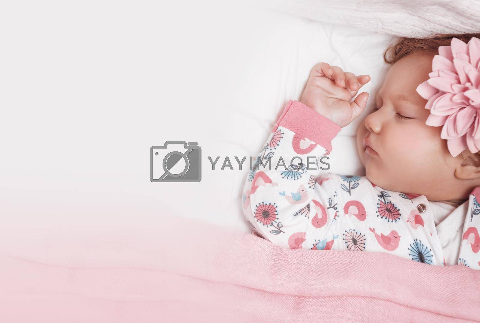 Portrait of an Adorable Baby Girl With Cute Pink Flower Hairpin Peacefully Sleeping in the Crib at Home. Photo with Copy Space. Healthy Babies Life Concept.