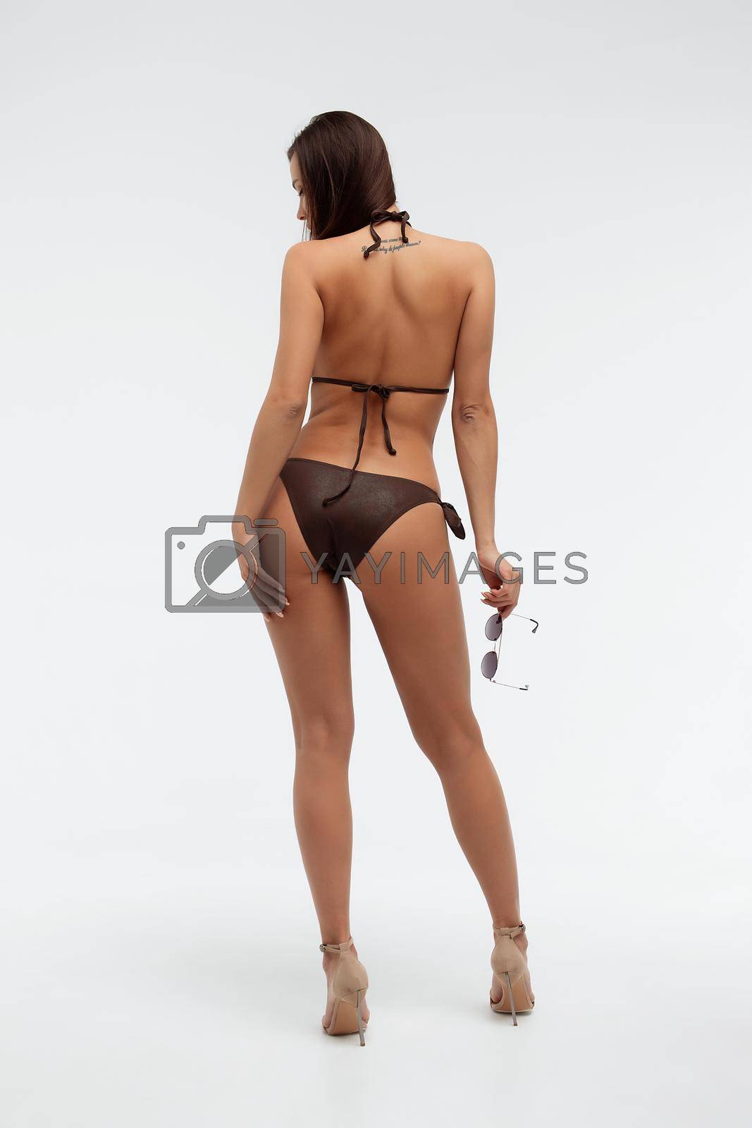 Royalty free image of Sexy slim model in stylish black swimsuit by 3KStudio