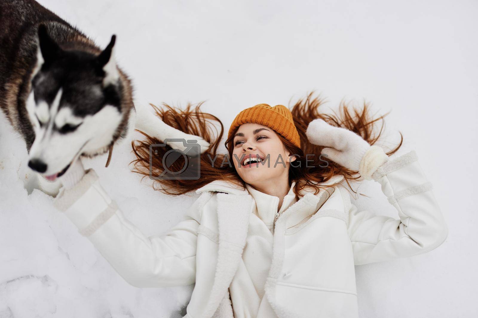 portrait of a woman winter clothes walking the dog in the snow Lifestyle. High quality photo