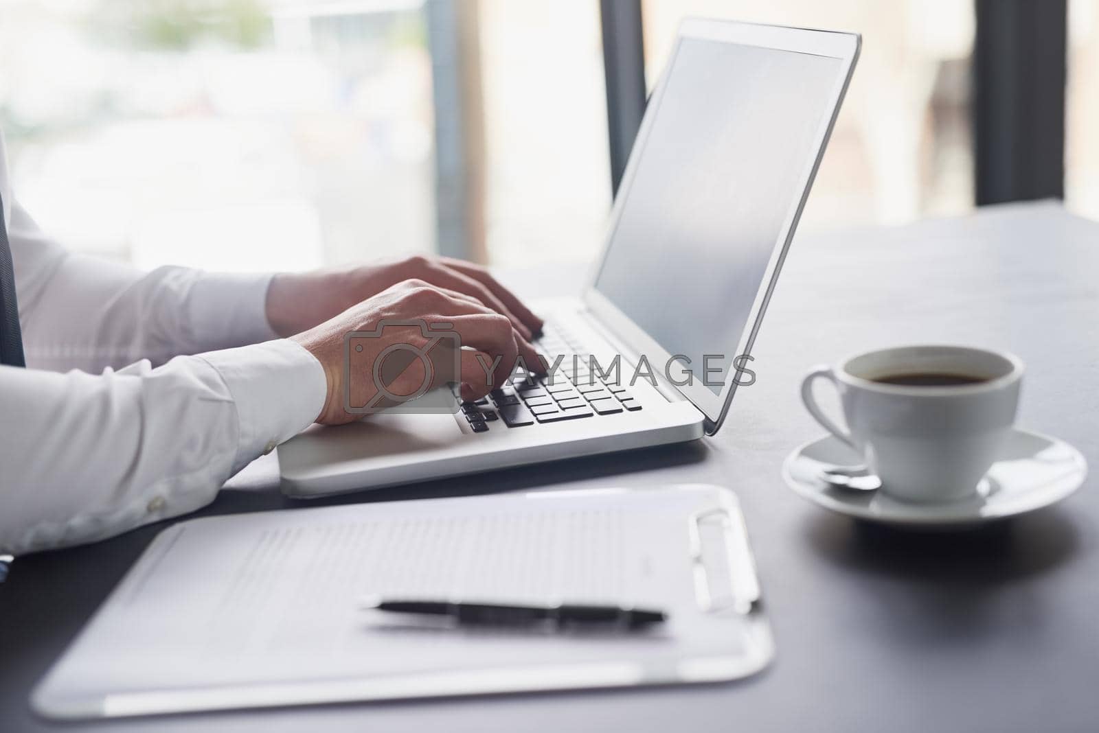 Royalty free image of Transferring analog to digital. Shot of a white collar businessman working in his office. by YuriArcurs