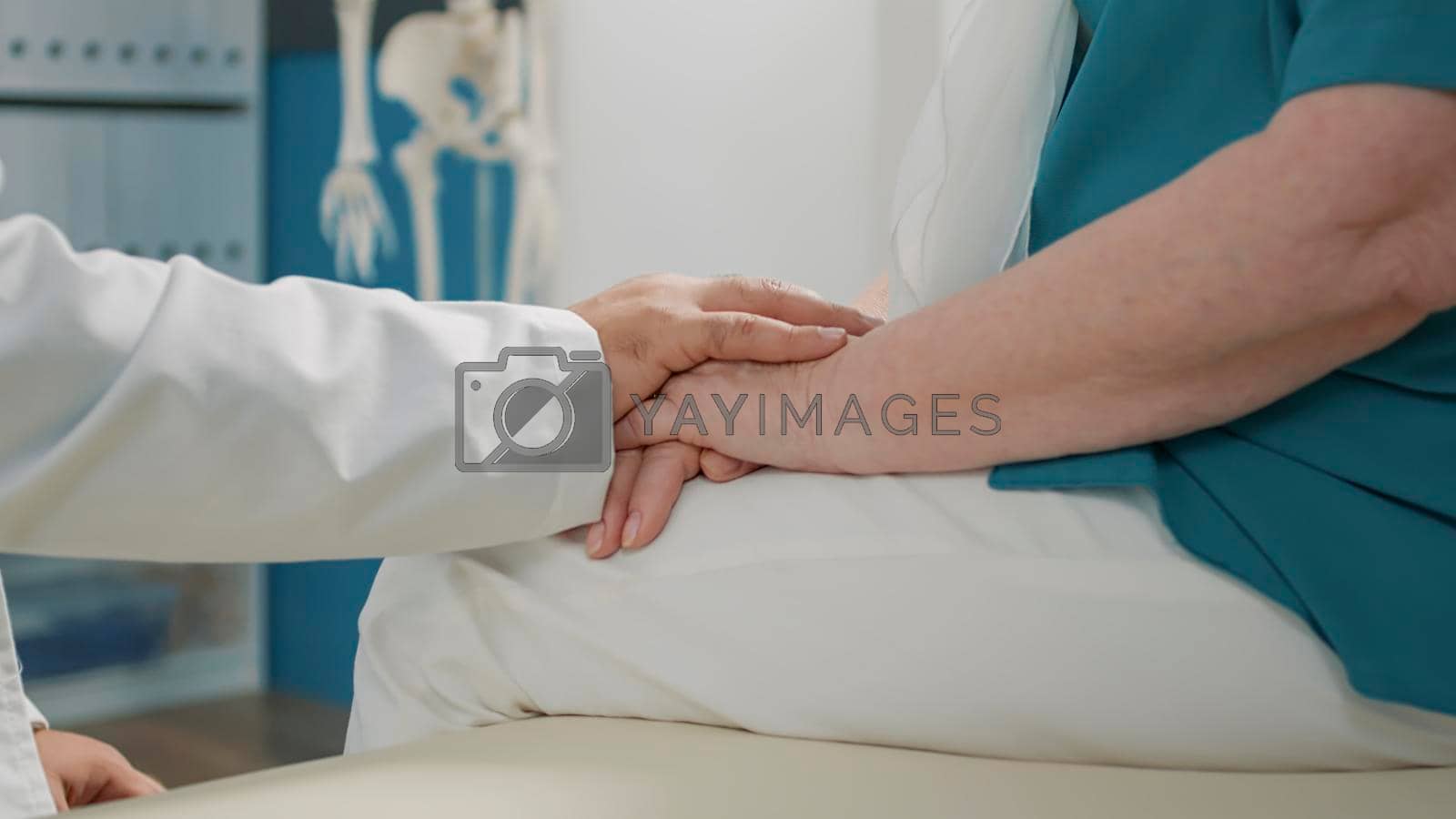 Royalty free image of Physician showing compassion to old patient at appointment by DCStudio