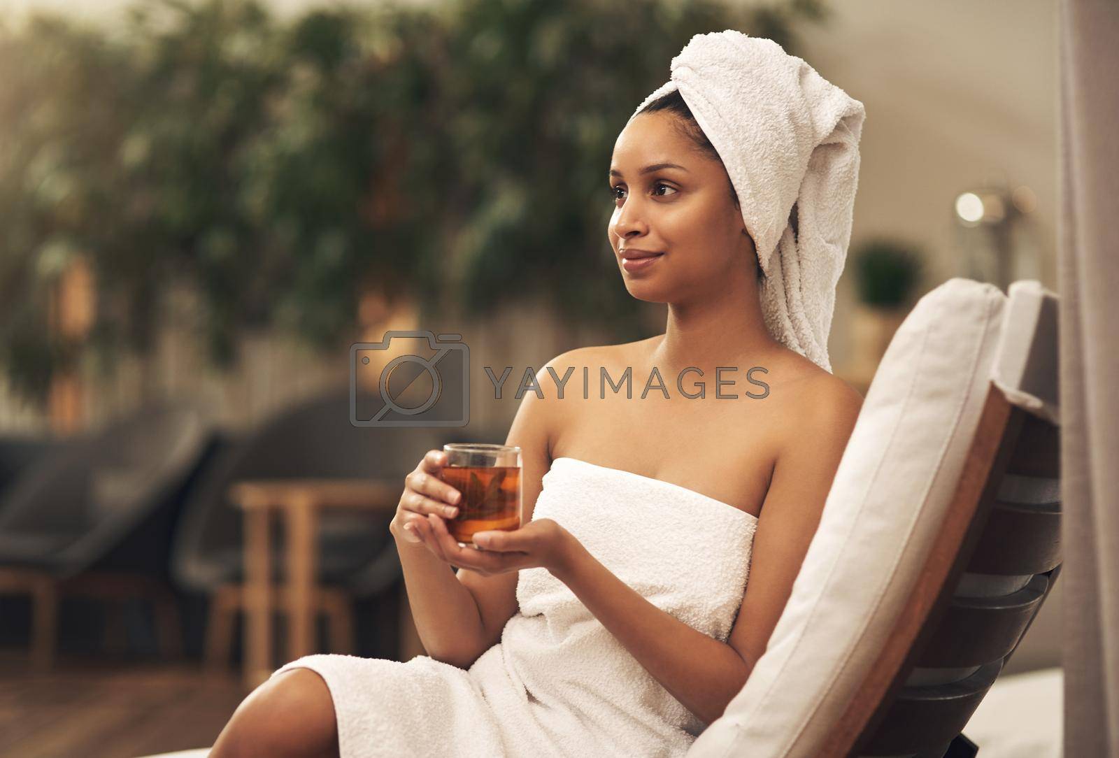 Shot of a woman drinking tea while enjoying a spa day.