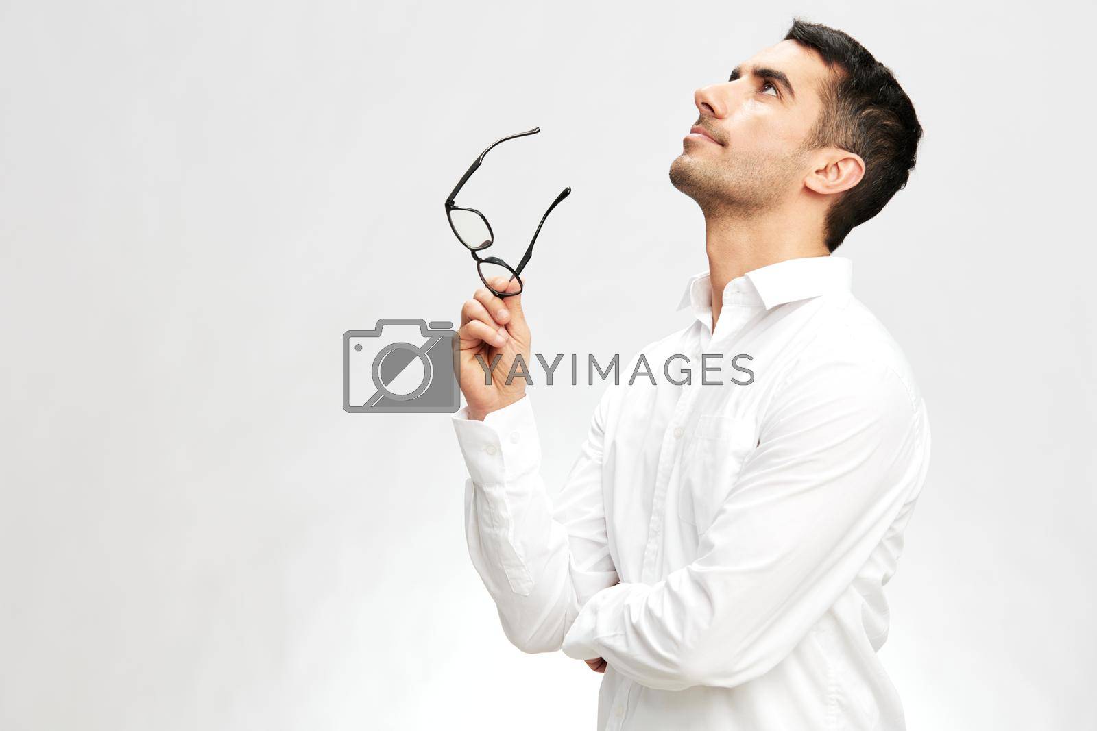 handsome businessman white shirt posing hand gesture spectacled looking up. High quality photo