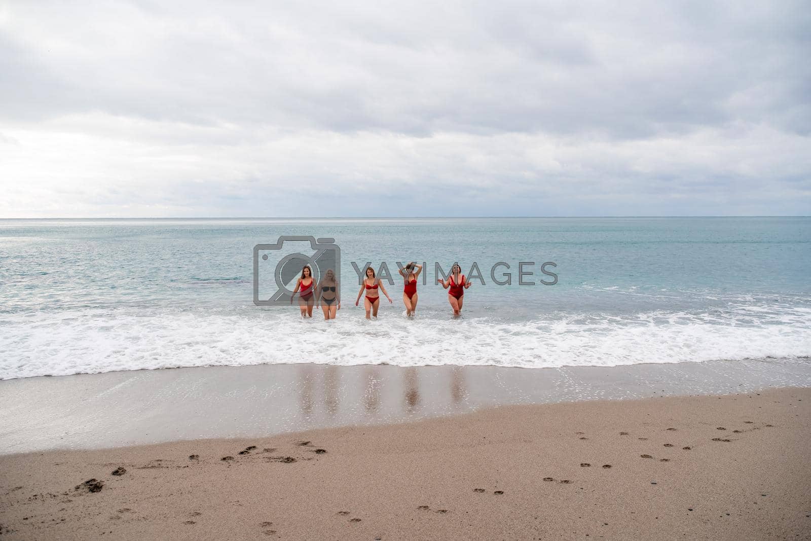 Royalty free image of Big happy family or group of five friends is having fun against sunset beach. Beach holidays concept. by Matiunina