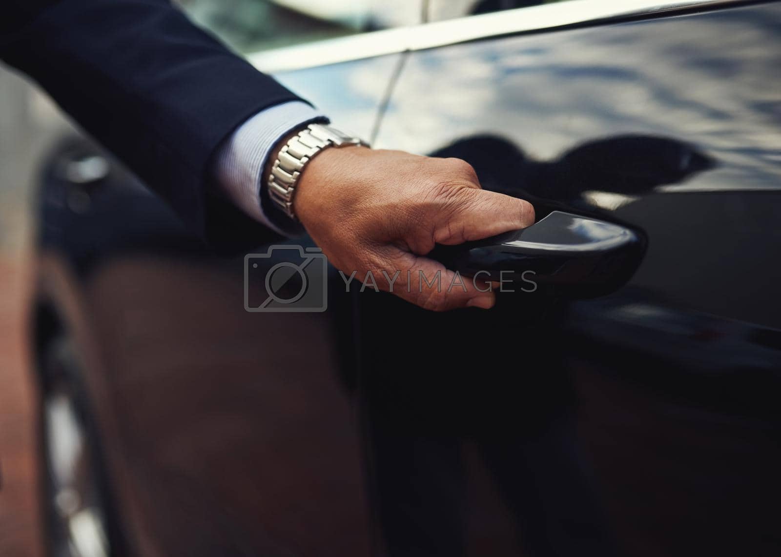 Cropped shot of a businessman opening a car door.
