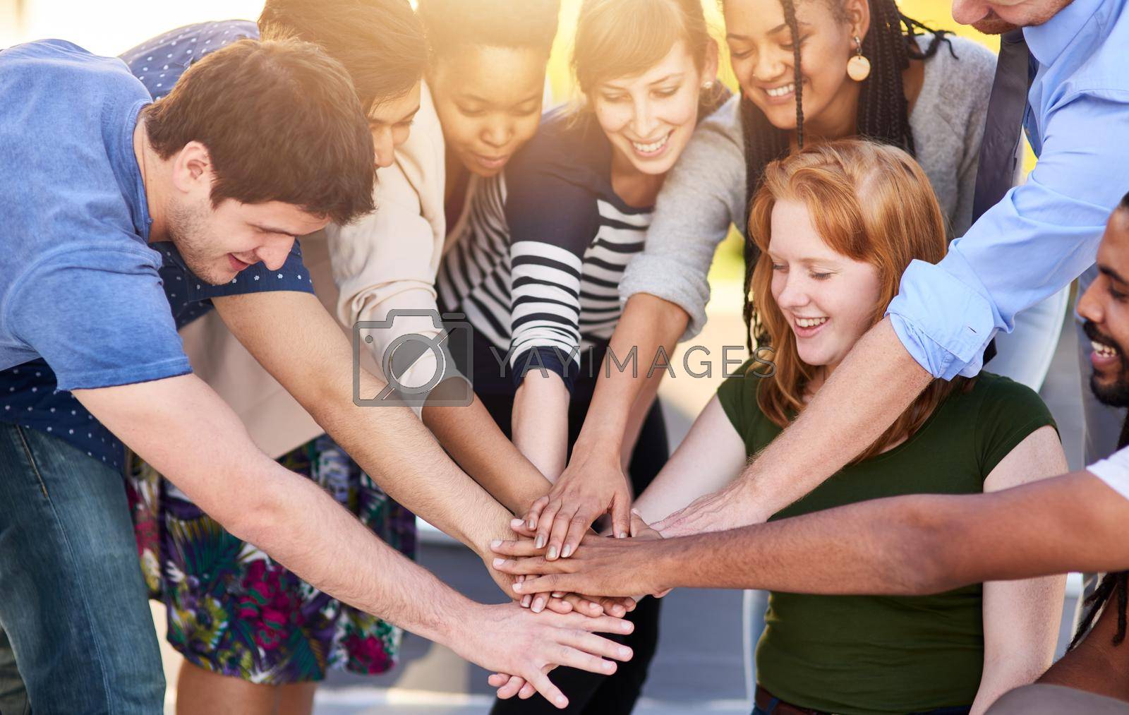 Shot of a group of people putting their hands together.