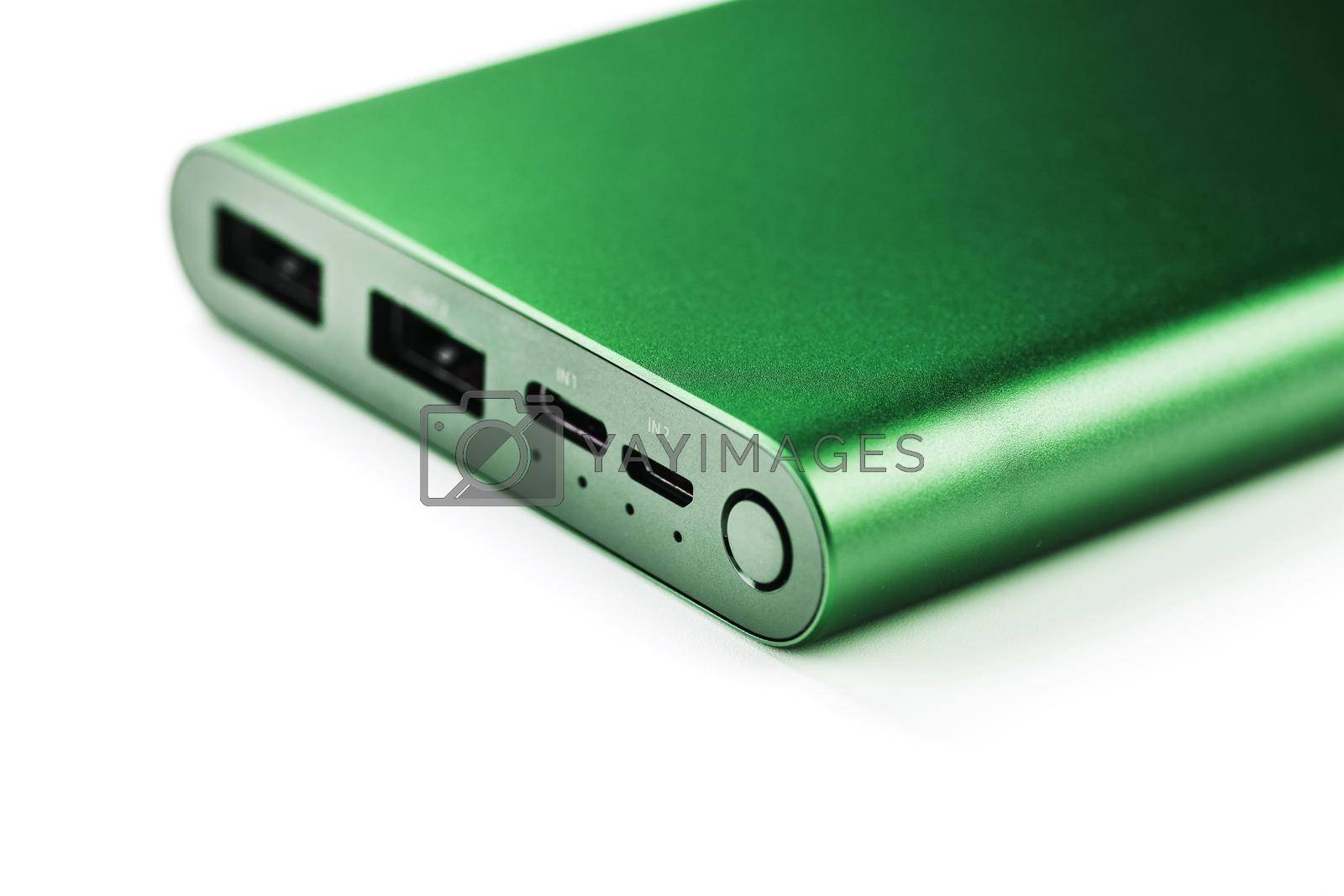 Royalty free image of Green Power Bank on a white background for charging mobile devices by AlexGrec