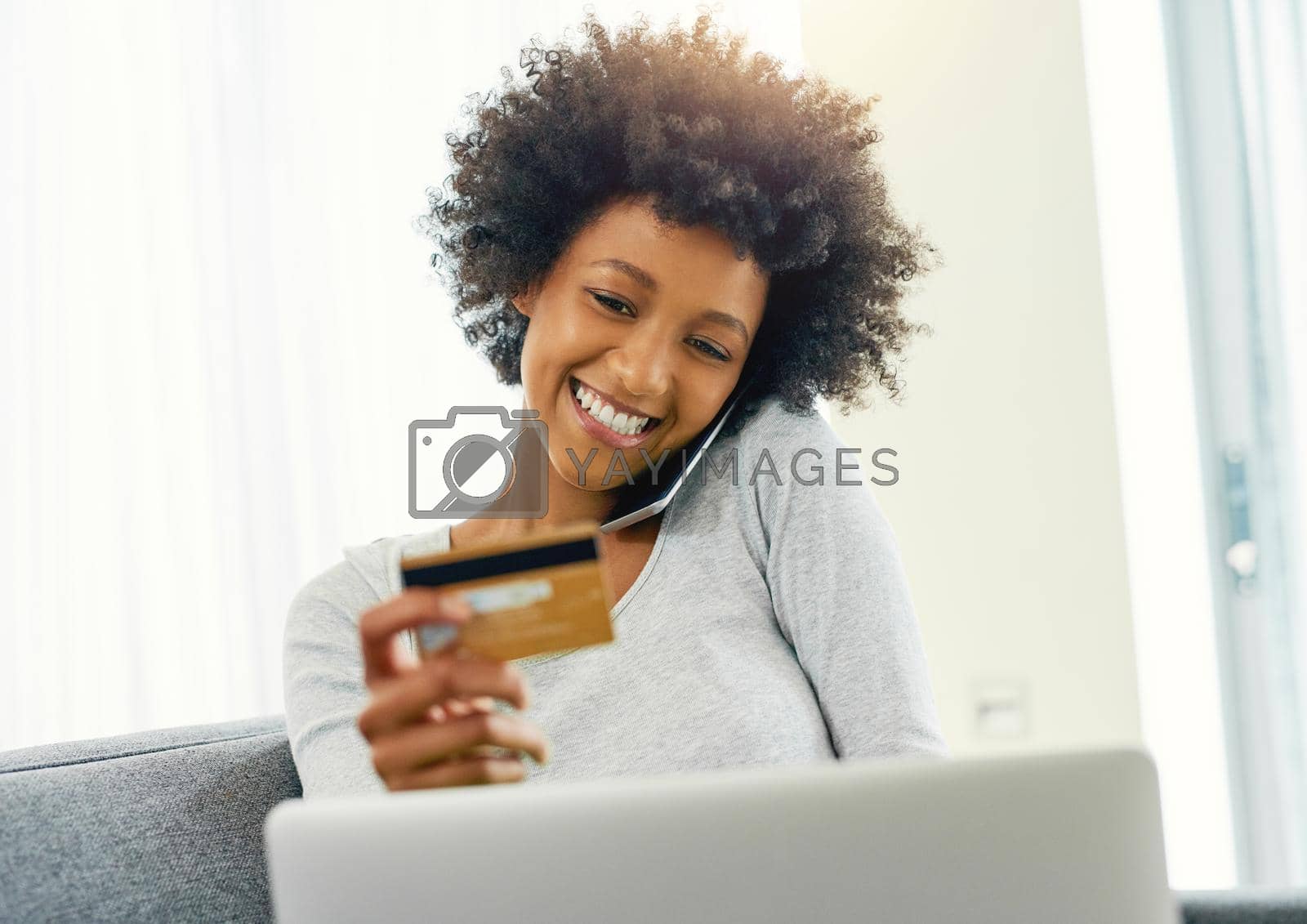 Royalty free image of Sure, Ive got the digits right here. Cropped shot of an attractive young woman using her laptop to shop online at home over the weekend. by YuriArcurs