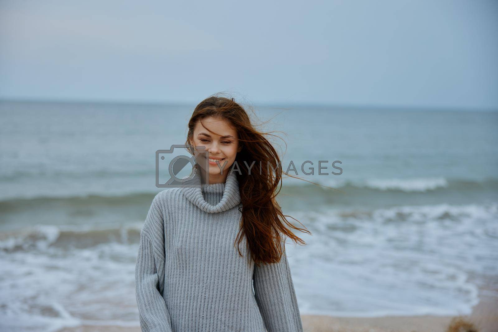 cheerful woman cloudy weather by the sea travel fresh air unaltered. High quality photo
