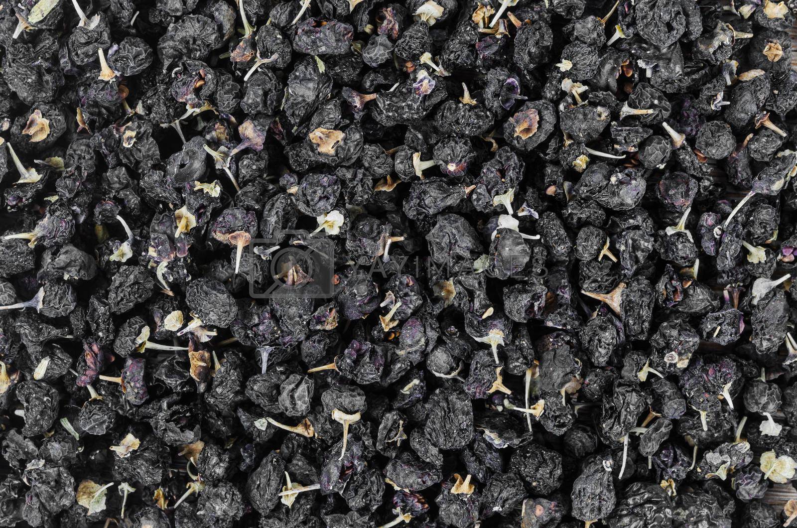 The Black wolfberries or black goji berries texture as background.