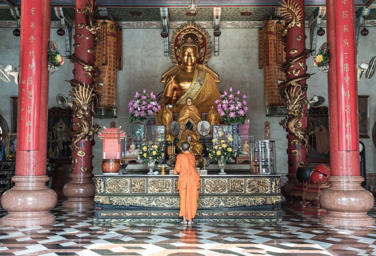 Bangkok, Thailand - Feb 08, 2020 : A buddhist Monk is worshiping and praying pay respect in front of the Golden buddha statue inside the Wat Bhoman Khunaram (Bhoman Khunaram Temple). Worship pray meditate to calm the mind, Focus and blur.