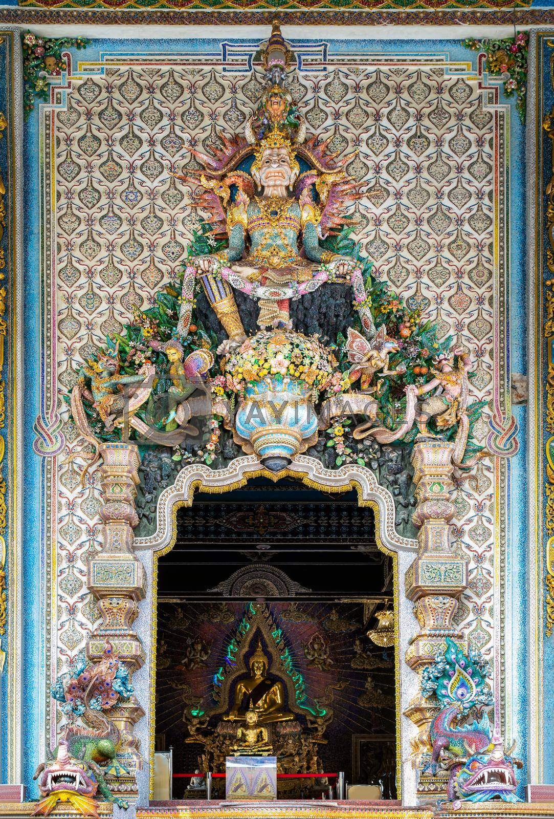 Bangkok, Thailand. Feb - 10, 2022 : Elaborate sculptures entrance the Buddhist church at the famous of The Pariwas Ratchasongkram temple. Selective Focus.