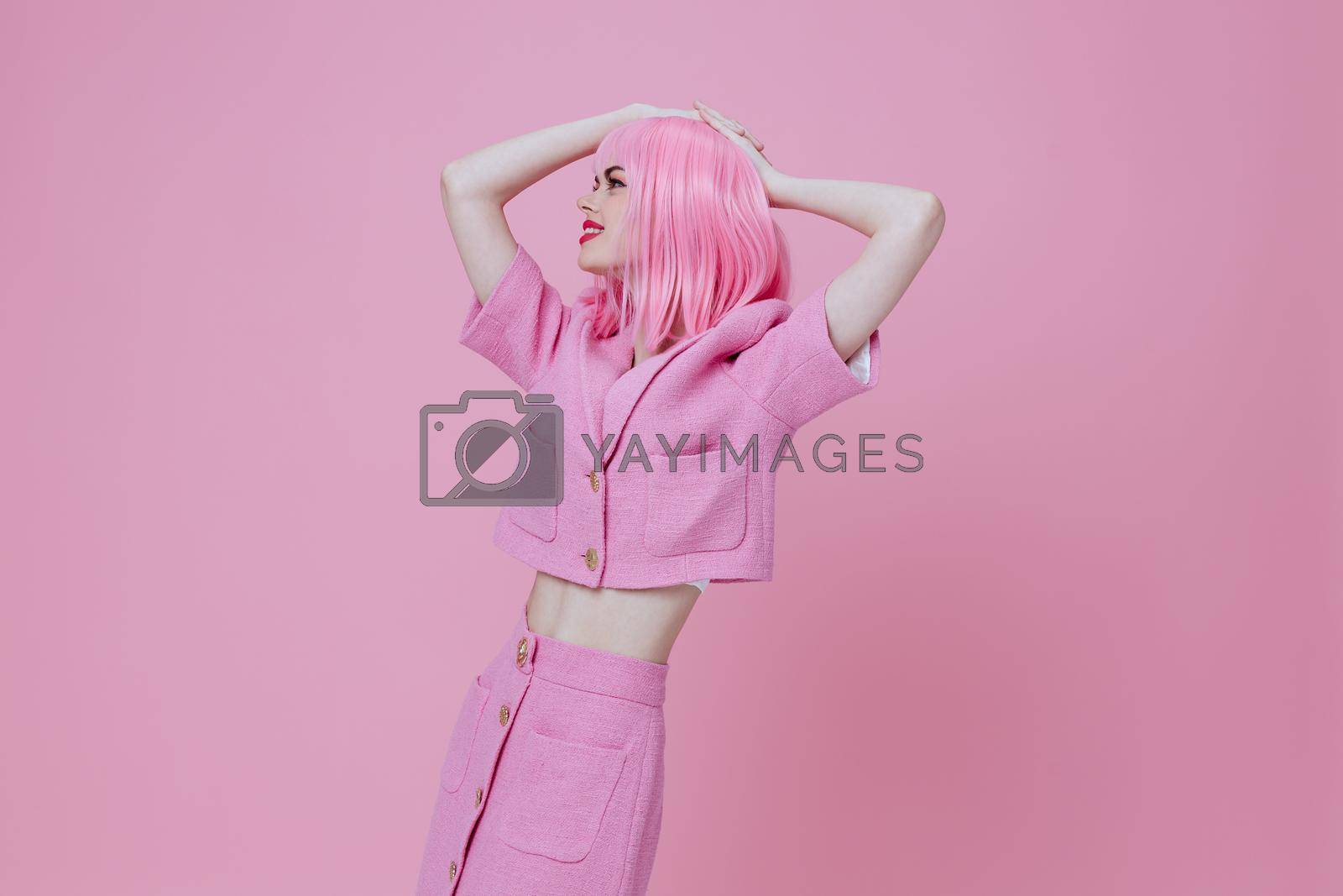 Pretty young female gesturing with hands pink jacket lifestyle glamor color background unaltered. High quality photo