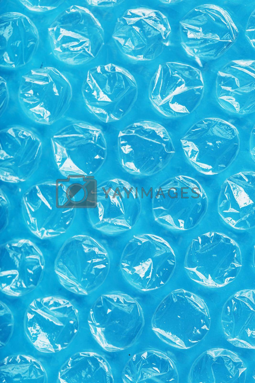 Packing bubble wrap for parcels on a blue background in full screen