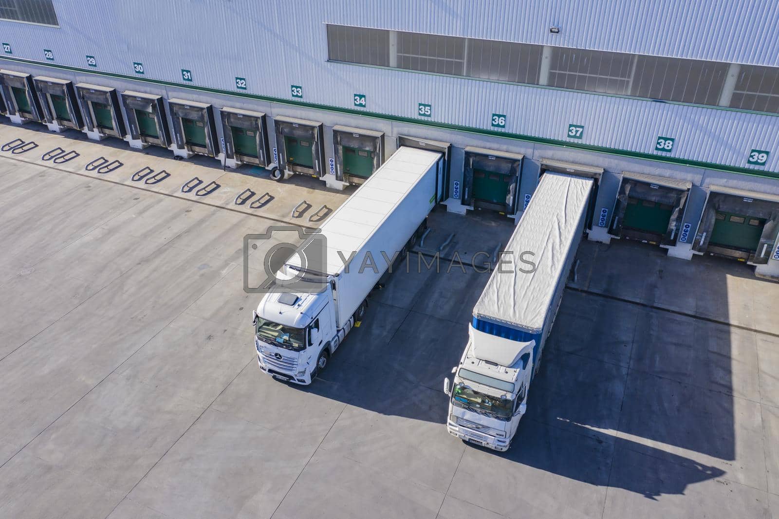 Royalty free image of Top view at a Big distribution warehouse with gates for loads and trucks. Aerial View by yourphotovideo