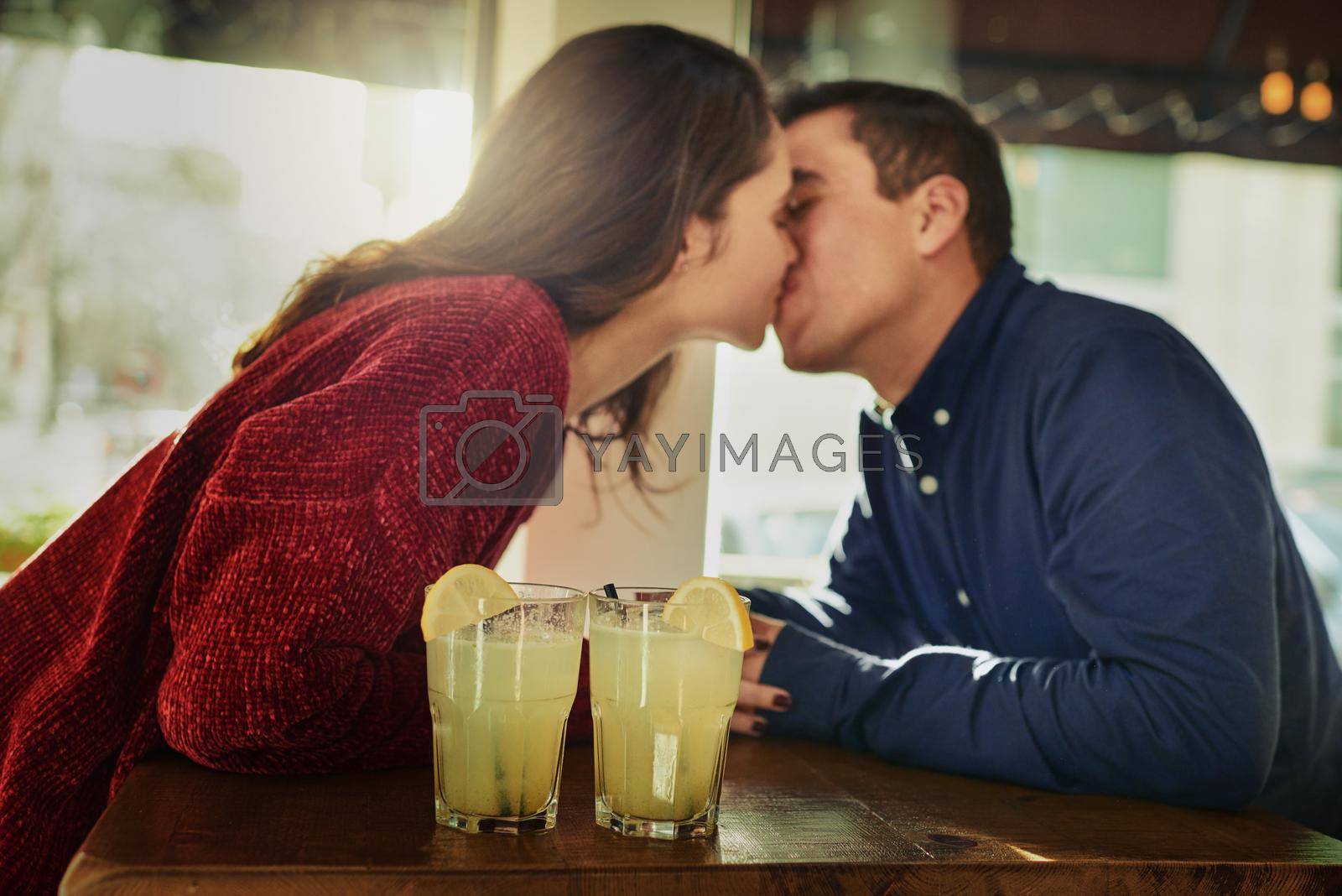 Royalty free image of And suddenly everything made sense.... Shot of a young man and woman on a romantic date at a coffee shop. by YuriArcurs