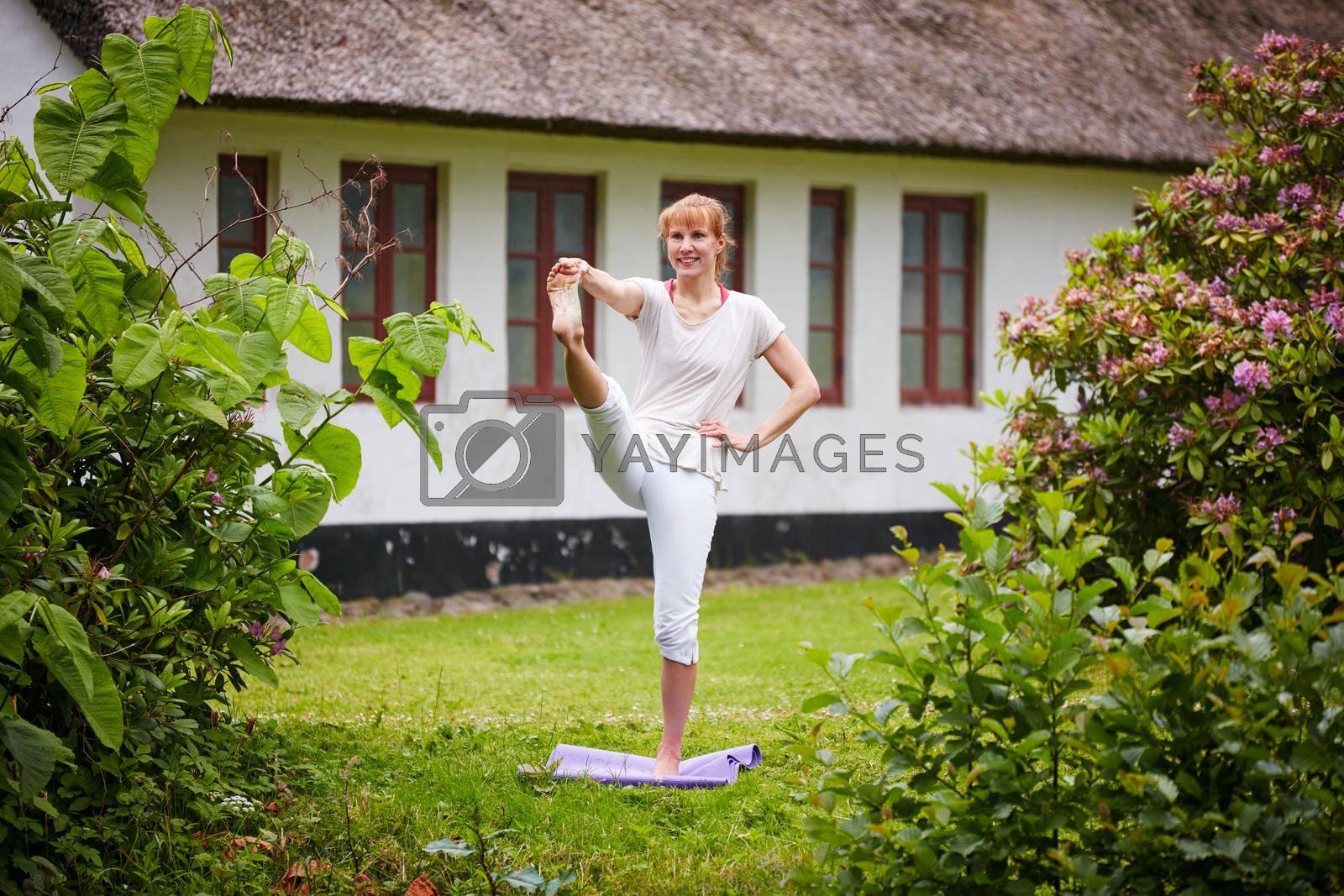 Shot of a woman practicing yoga in her backyard.