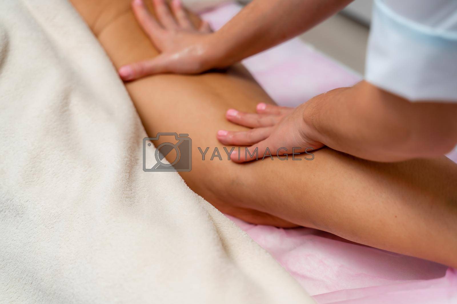 Facial massage. A woman is given a massage in a beauty salon. Close-up