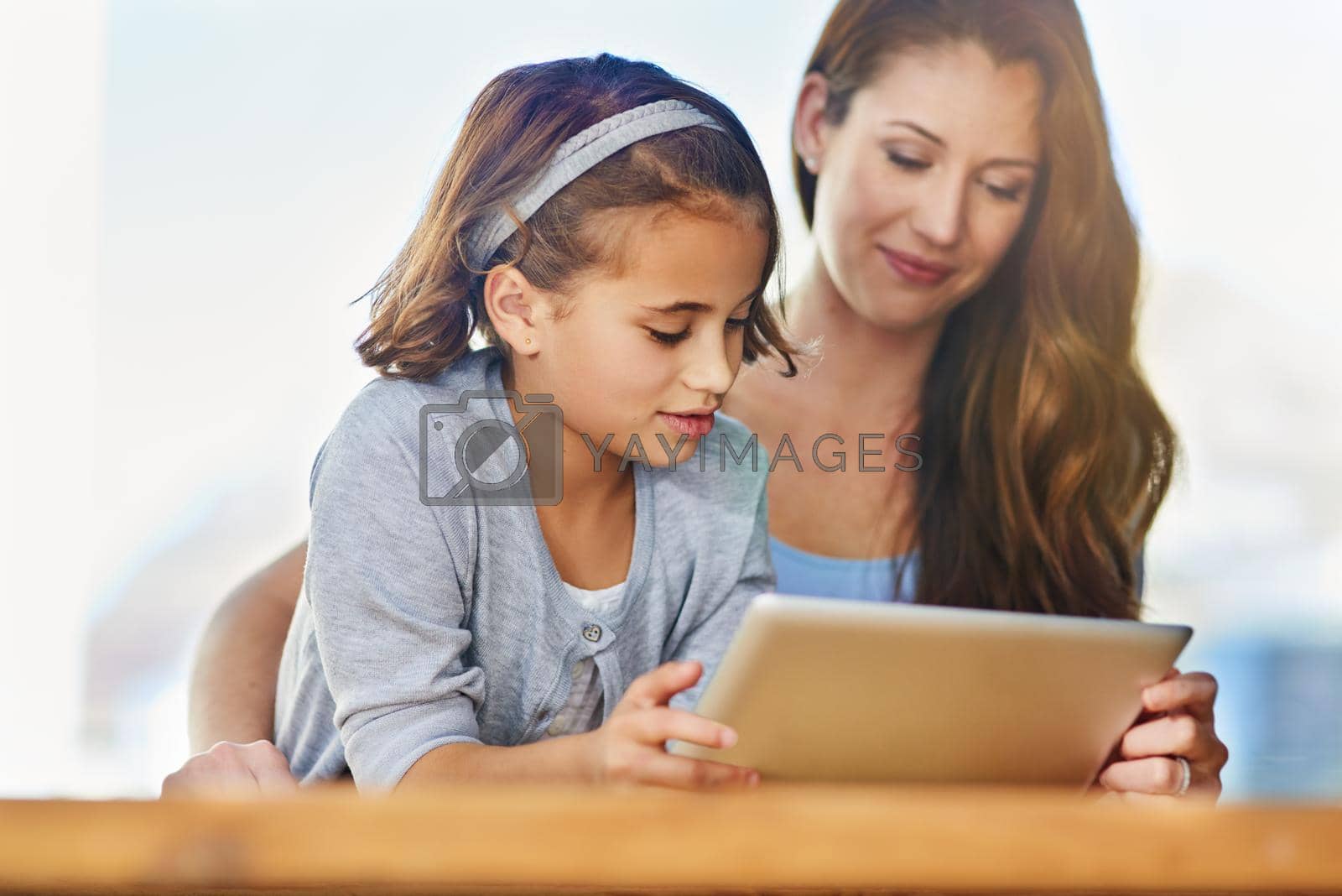 Cropped shot of a mother and her daughter using a digital tablet.