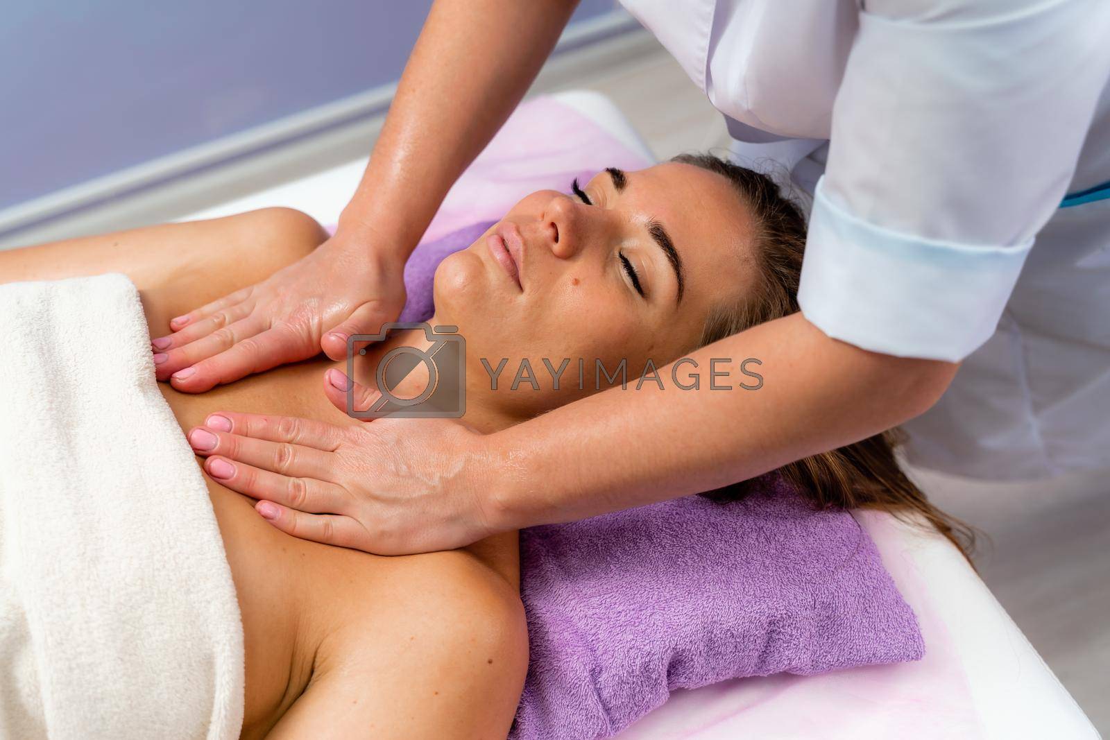 Facial massage. A woman is given a massage in a beauty salon. Close-up.
