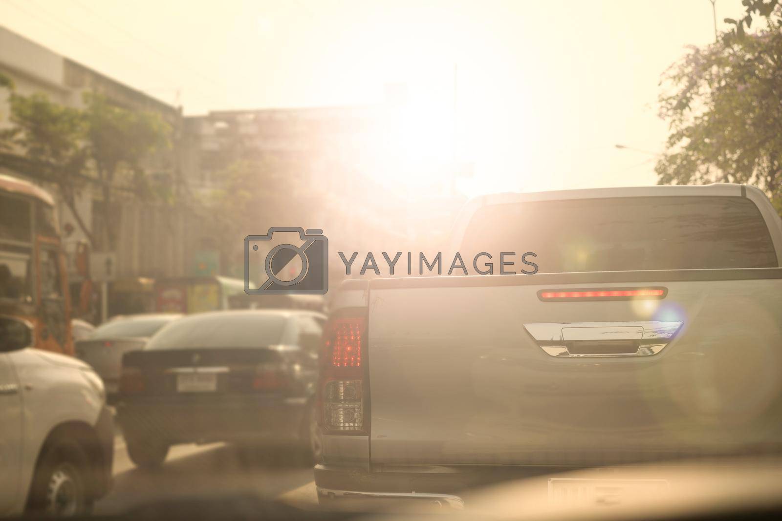 Royalty free image of traffic car in city with sun by VacharapongW